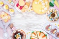 Easter or spring dessert food frame. Top down view over a white wood background. Royalty Free Stock Photo