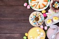 Easter or spring dessert food side border. Above view over a dark wood background. Royalty Free Stock Photo