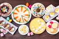 Easter or spring dessert food table scene. Top down view over a dark wood background. Royalty Free Stock Photo