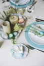 Easter and spring festive table decorated in blue and white tones in natural rustic style, with eggs, bunny, fresh flowers Royalty Free Stock Photo