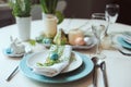 Easter and spring festive table decorated in blue and white tones in natural rustic style, with eggs, bunny, fresh flowers Royalty Free Stock Photo