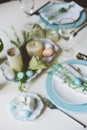 Easter and spring festive table decorated in blue and white tones in natural rustic style, with eggs, bunny, fresh flowers Royalty Free Stock Photo