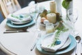 Easter and spring festive table decorated in blue and white tones in natural rustic style, with eggs, bunny, fresh flowers Royalty Free Stock Photo