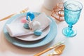 Easter and spring festive table decorated in pink and blue colours with modern golden metallic cutlery