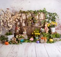 Easter spring sett up with colourful flowers pink and yellow flowers,bunny and easter eggs and vintage wood parquet Royalty Free Stock Photo