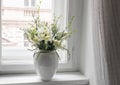 Easter spring still life. Floral bouquet on window sill. White and yellow tulips, daffodils flowers and green birch tree Royalty Free Stock Photo