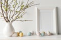 Easter spring tree with eggs vase at white home interior. Generative AI