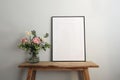 Easter springtime still life. Blank black picture frame mockup on wooden bench, table. Spring bouquet of pink tulips Royalty Free Stock Photo