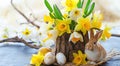 Easter still life with bouquet of daffodils in vase from bark of wood, Easter eggs and cute rabbit