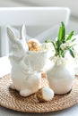 Easter still life with a ceramic hare, eggs and flowers. Royalty Free Stock Photo