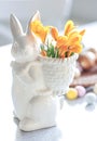 Easter still life with a ceramic hare, eggs and flowers. Royalty Free Stock Photo