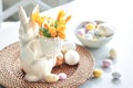 Easter still life with a ceramic hare, eggs and flowers. Royalty Free Stock Photo