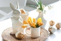 Easter still life with a ceramic hare, eggs and flowers. Royalty Free Stock Photo
