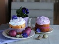 Easter still life, Easter cake, chicken and quail eggs, on a violet and gray textile background. Royalty Free Stock Photo