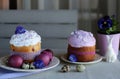 Easter still life, Easter cake, chicken and quail eggs, on a violet and gray textile background. Royalty Free Stock Photo