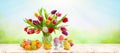 Easter still life with Easter eggs, bouquet of colorful tulips and chicks on wooden table. Happy Easter concept Royalty Free Stock Photo