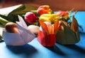 Easter still life. Paper rabbits. Easter Golden eggs. On the blue table, a bouquet of tulips Royalty Free Stock Photo