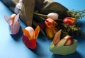 Easter still life. Paper rabbits. Origami. Easter Golden eggs. On the blue table, a bouquet of tulips Royalty Free Stock Photo