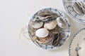 Easter still life. Vintage blue floral plates with traditional speckled eggs with feather isolated on white table Royalty Free Stock Photo