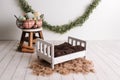 Easter studio set mock up, wood bed with brown mattress and garland