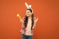 Easter Sunday. child wearing bunny ears. Funny decoration. little girl rabbit hold carrot. collecting and painting eggs Royalty Free Stock Photo