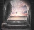 Easter Sunday concept: Tomb empty with cross on sunset background Royalty Free Stock Photo