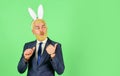 Easter Sunday. Happy businessman advertising product. Bearded man with bunny ears pointing. Presenting product. Product