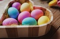 Easter symbol - colored eggs in a heart shaped bowl Royalty Free Stock Photo