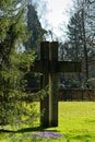 Large stone cross on bright green lawn in park, Good Friday Royalty Free Stock Photo