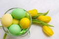 Easter table centerpiece with yellow tulips and painted eggs in Royalty Free Stock Photo