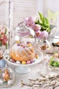 Easter table with ring cake and decors under a glass cloche