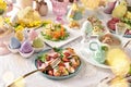 Easter table with salads and white borscht with quail egg and sausage skewer Royalty Free Stock Photo