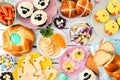 Easter table scene with a selection of breads, desserts and treats, above view over a white wood background Royalty Free Stock Photo