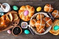 Easter table scene with a selection of fresh breads, top view over a dark wood background Royalty Free Stock Photo