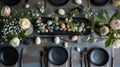 Easter table setting with black plates, colorful eggs, and fresh spring flowers, AI-generated. Royalty Free Stock Photo