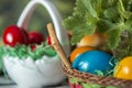 Easter table setting with colored red eggs, bread, green branches decorated, over white plank wooden table with textile Royalty Free Stock Photo