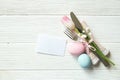 Easter laying table appointments, table setting options. Silverware, tableware items with festive decoration. Fork, knife and flow Royalty Free Stock Photo