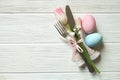 Easter laying table appointments, table setting options. Silverware, tableware items with festive decoration. Fork, knife and flow Royalty Free Stock Photo