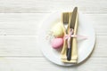 Easter laying table appointments, table setting options. Silverware, tableware items with festive decoration. Fork, knife and flow