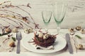 Easter table setting with eggs and spring decoration on rustic background Royalty Free Stock Photo