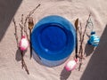 Easter table setting empty blue glass plate cutlery tree branches linen cloth flat lay harsh shadow Festive dish place Royalty Free Stock Photo