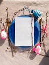 Easter table setting empty blue glass plate cutlery tree branches linen cloth flat lay harsh shadow Festive dish place Royalty Free Stock Photo