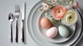 Easter table setting with pastel eggs, ranunculus flowers, silverware. Elegant spring holiday decoration, minimalist dining Royalty Free Stock Photo