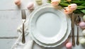 Easter table setting with pink eggs, tulips, and vintage cutlery on a rustic wooden background. Royalty Free Stock Photo