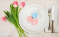 Easter table setting with pink tulips on white wooden background Royalty Free Stock Photo