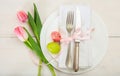 Easter table setting with pink tulips on white wooden background Royalty Free Stock Photo