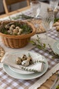 Easter table setting with quail eggs. Rustic table setting with quail eggs for Easter holiday Royalty Free Stock Photo
