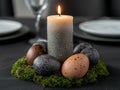 Easter table setting with speckled eggs and candle Royalty Free Stock Photo