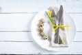 Easter table setting with spring flowers, eggs and cutlery Royalty Free Stock Photo