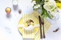 Easter table settings with painted eggs and spring flowers. Royalty Free Stock Photo